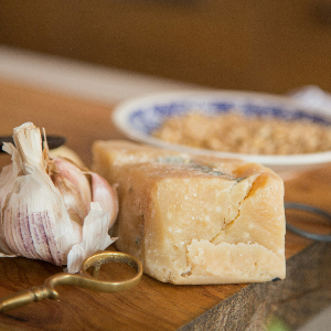 a block of parmesan cheese on a cutting board