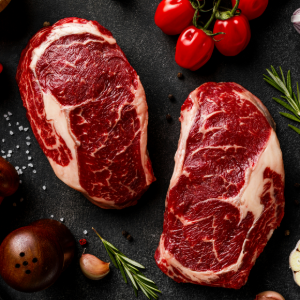 two raw steaks on a plate