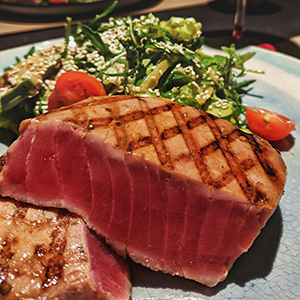 a seared tuna steak on a plate